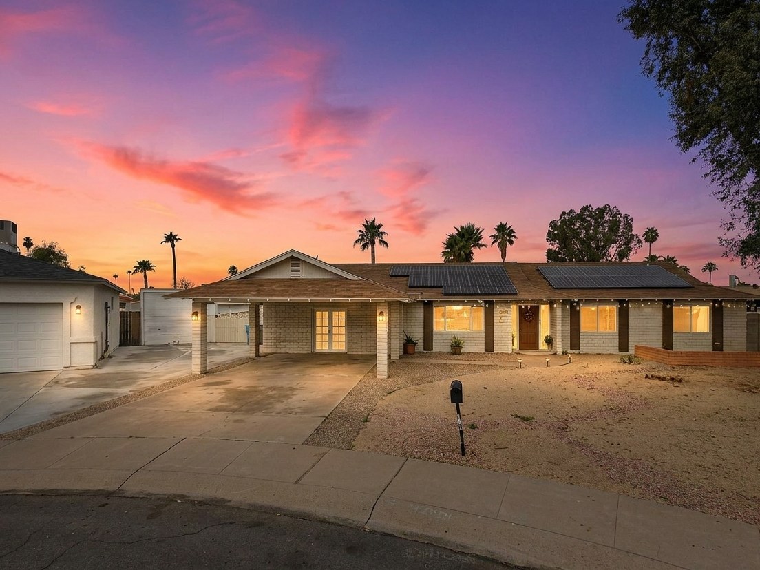 The same house with a Sonoran sunset sky and warm lighting